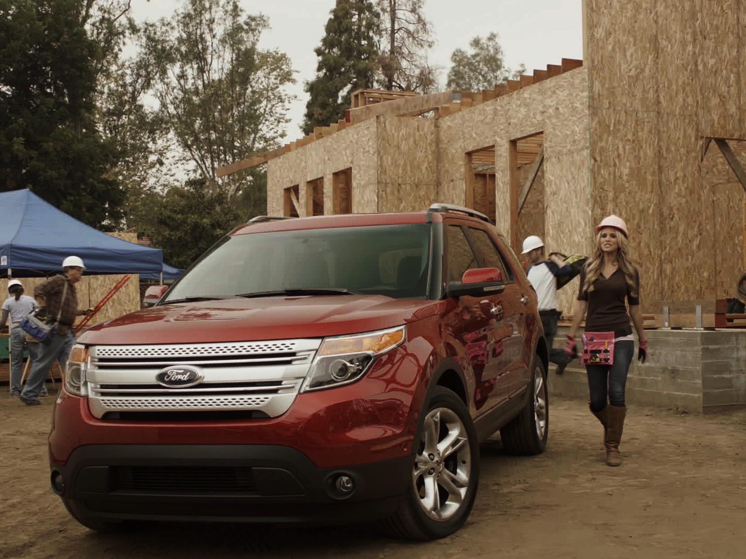 Red Ford Explorer at a construction site during a product demonstration