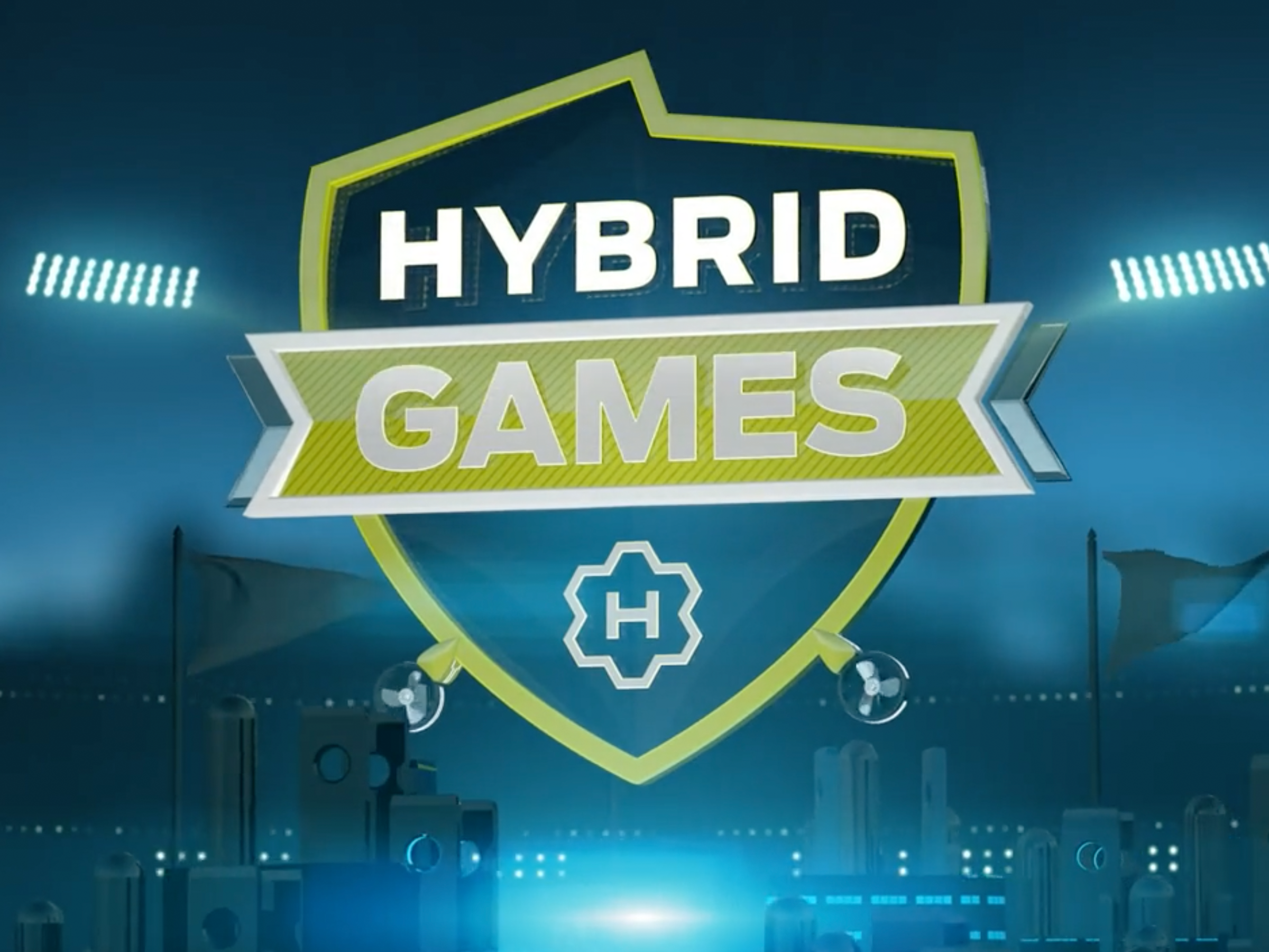 Hybrid Games shield logo illuminated against a blue competition-stage backdrop