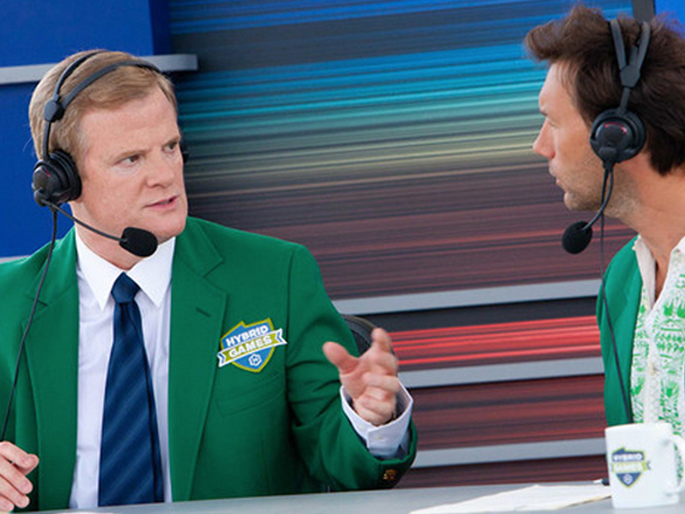 Hybrid Games sportscaster duo wearing green jackets and broadcast headsets
