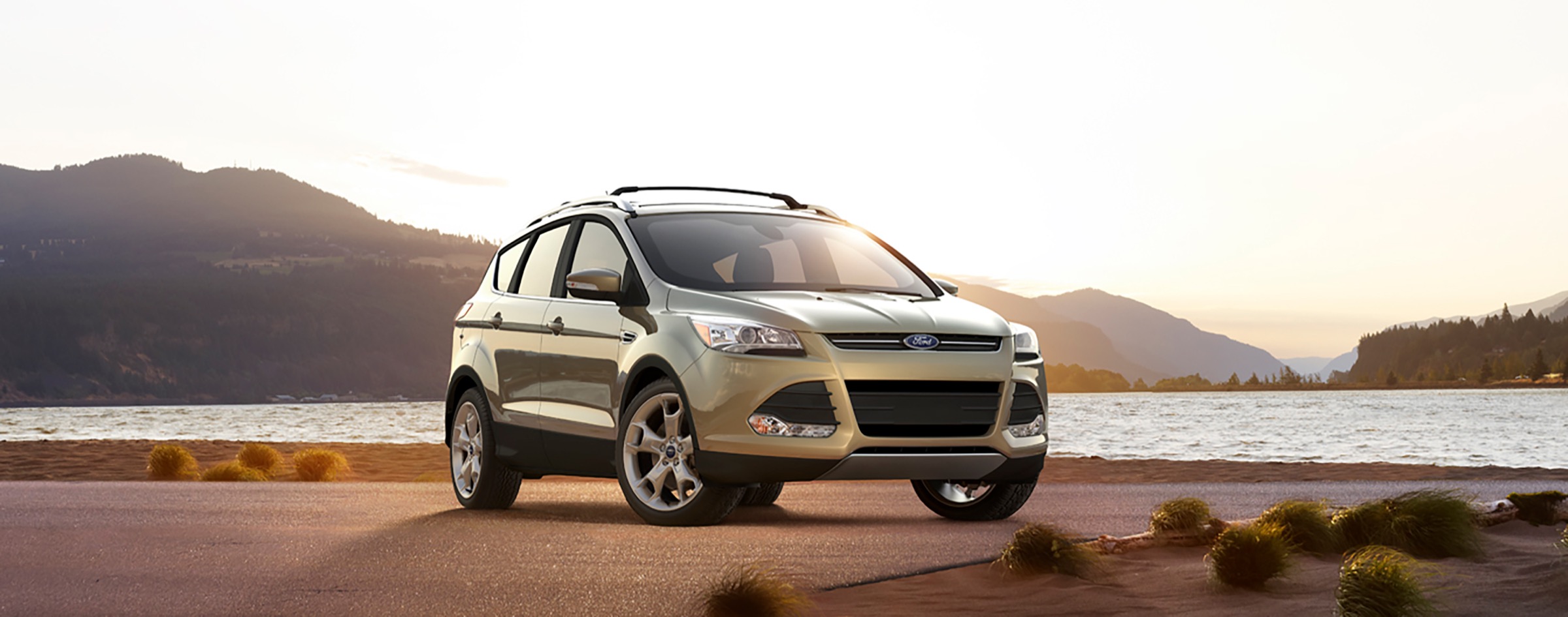 Ford Escape photographed beside a mountain lake at sunset